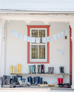 Porch with mudboots and welcome banner