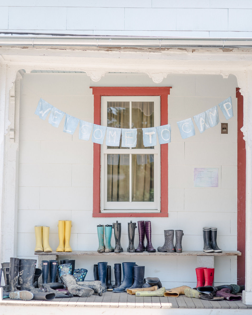 Porch with mudboots and welcome banner